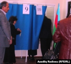 Parlament seçkisində eyni kabinədə səs verən iki seçici, 7 noyabr 2010