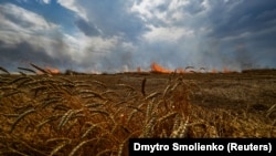 UKRAINE – A burning wheat field is seen near a frontline on a border between Zaporizhzhia and Donetsk regions, as Russia’s attack on Ukraine continues, July 17, 2022