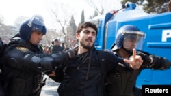 Azerbaijan -- Riot police detain a protester during a rally in Baku, 10Mar2013