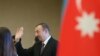 Azerbaijan -- President Ilham Aliyev waves after casting his ballot at a polling station in Baku, October 9, 2013