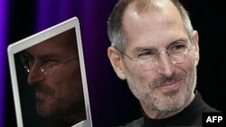 U.S. -- Apple CEO and co-founder Steve Jobs shows off the new Macbook Air ultra portable laptop during his keynote speech at the MacWorld Conference & Expo in San Francisco, 15Jan2008