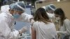 KAZAKHSTAN -- A woman receives a dose of Sputnik V (Gam-COVID-Vac) vaccine against the coronavirus disease (COVID-19) at the Palace of the Republic concert hall in Almaty, Kazakhstan April 2, 2021.